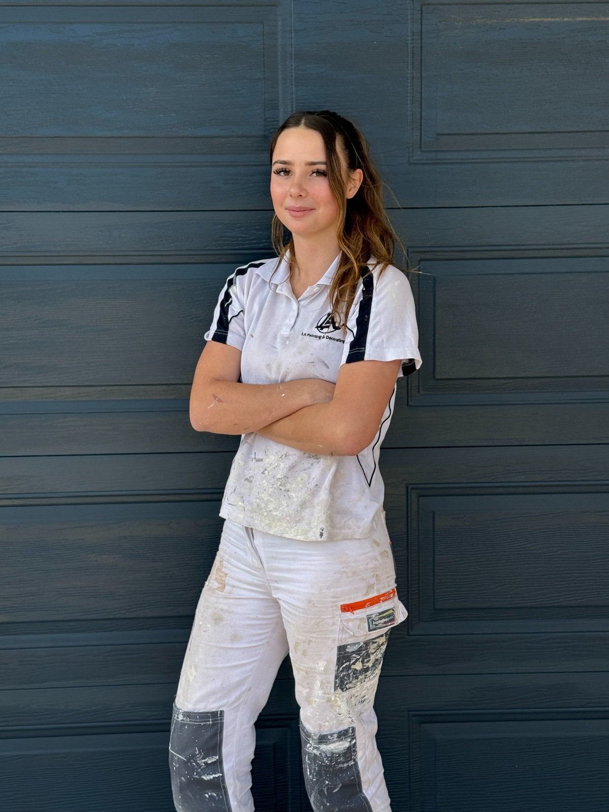 Erin, first year apprentice at LA Painting & Decorating, in branded uniform in Perth