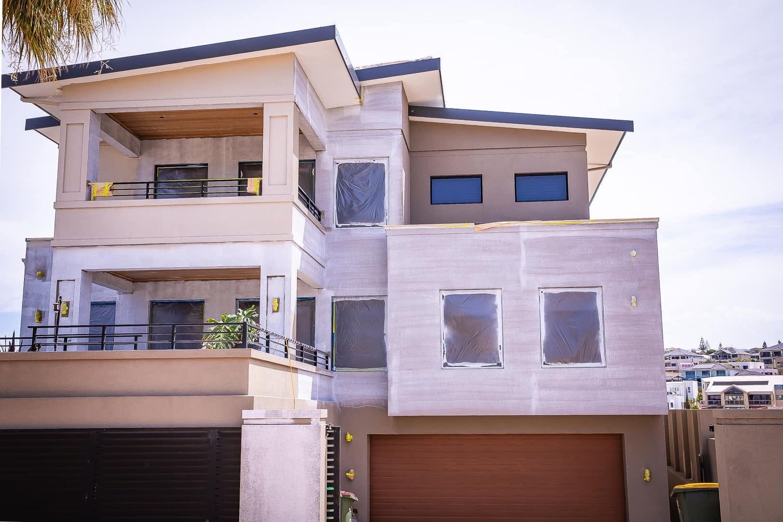 Rendered Perth home with windows masked and the exterior prepared and protected before an exterior repaint by LA Painting & Decorating
