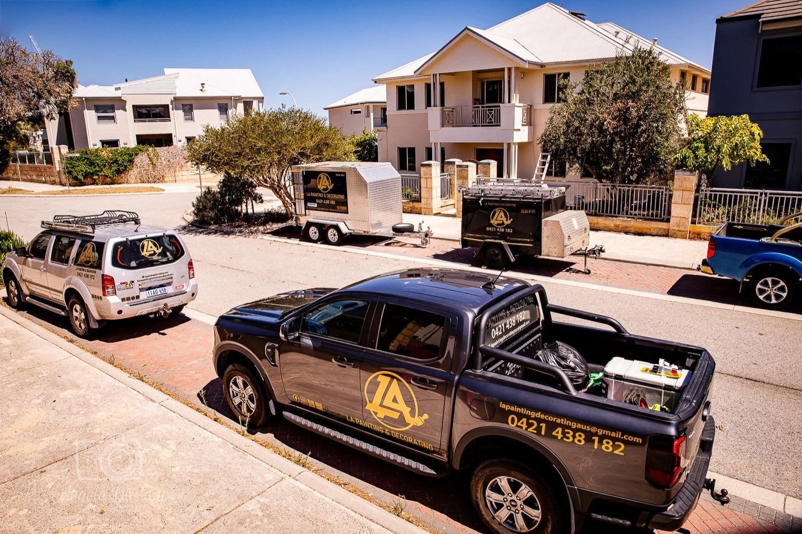 The LA Painting & Decorating team and work fleet in Perth